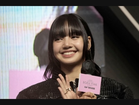 Lisa of BLACKPINK smiling on stage announcing her Viva La Lisa Las Vegas residency
