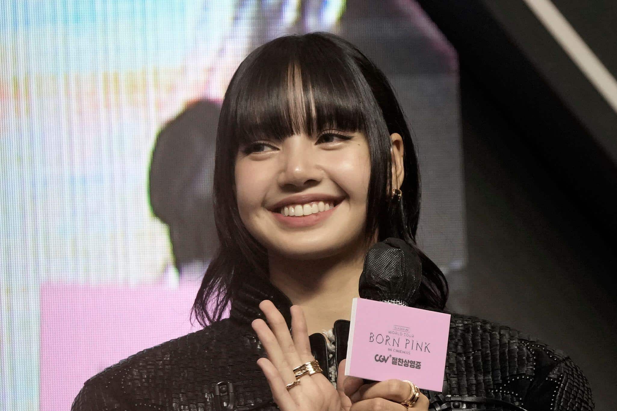 Lisa of BLACKPINK smiling on stage announcing her Viva La Lisa Las Vegas residency