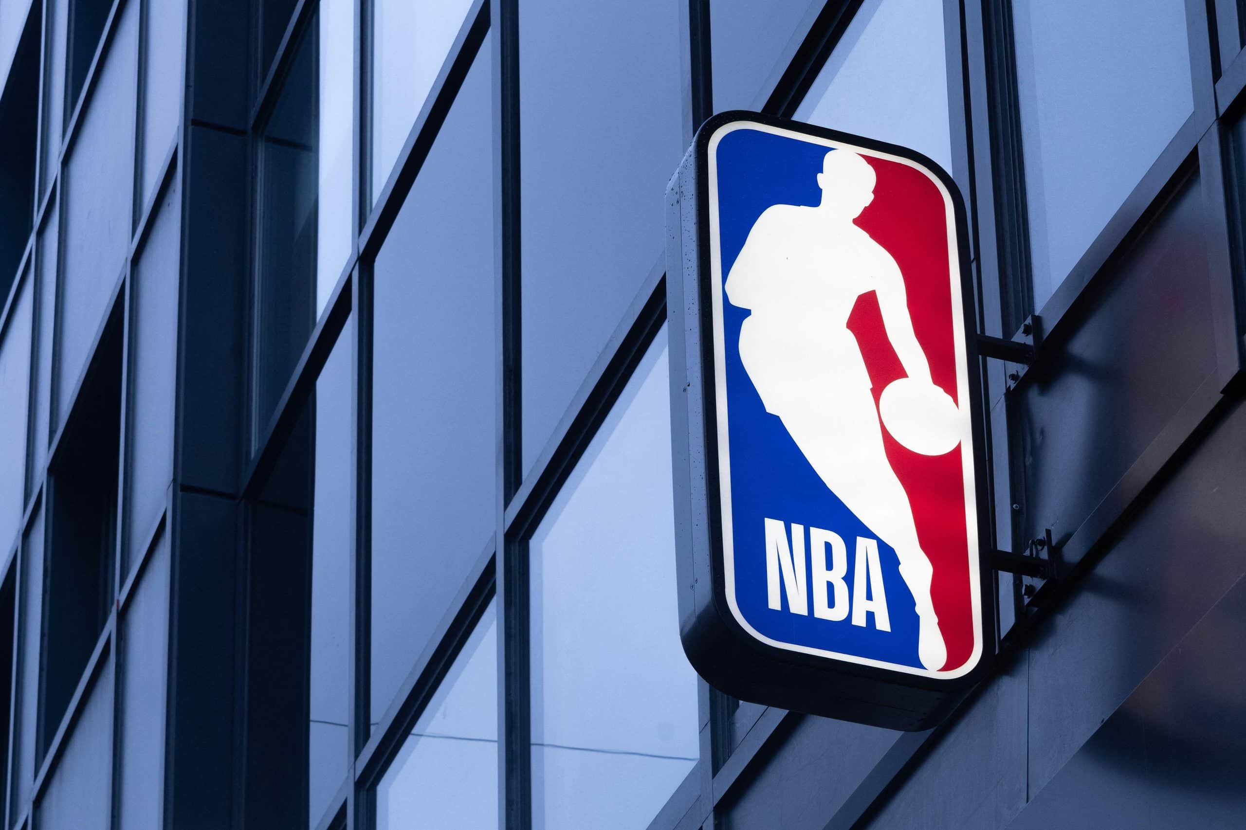 NBA logo sign mounted on the glass facade of an office building