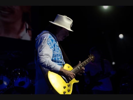 Santana playing guitar on stage during a Las Vegas residency performance