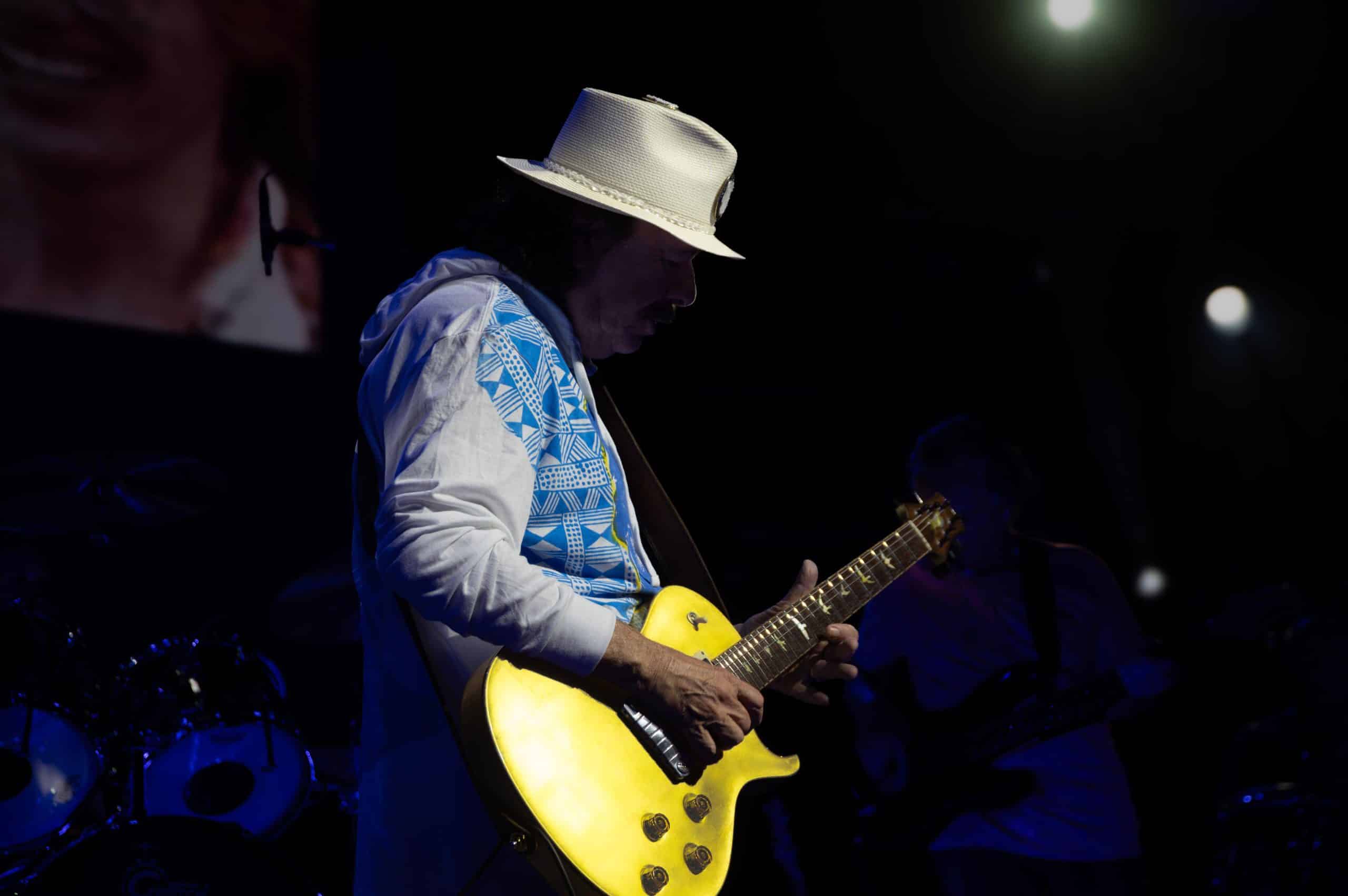 Santana playing guitar on stage during a Las Vegas residency performance